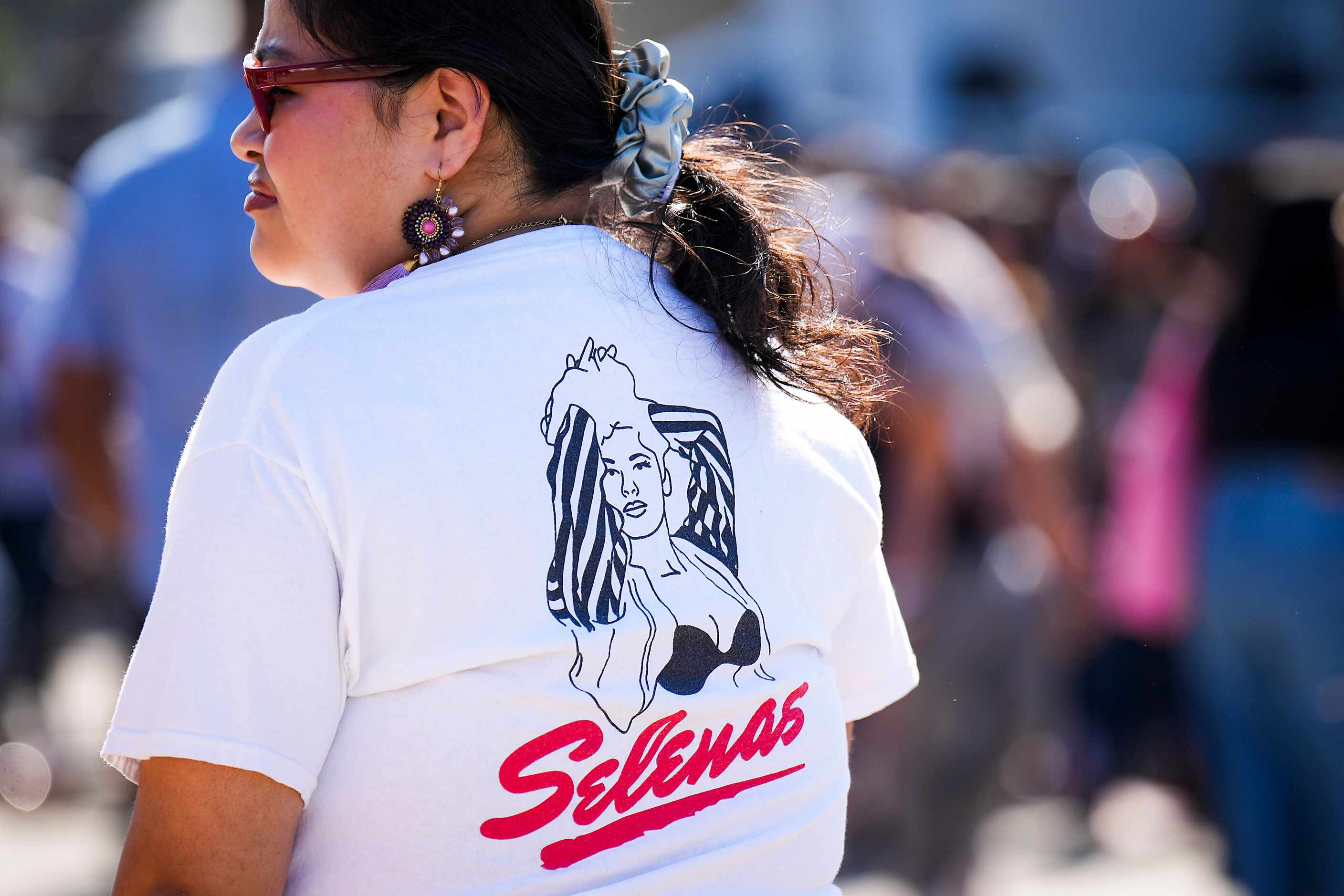 A woman wears a t-shirt showing Selena Quintanilla-Pérez during the 214Selena celebration,...