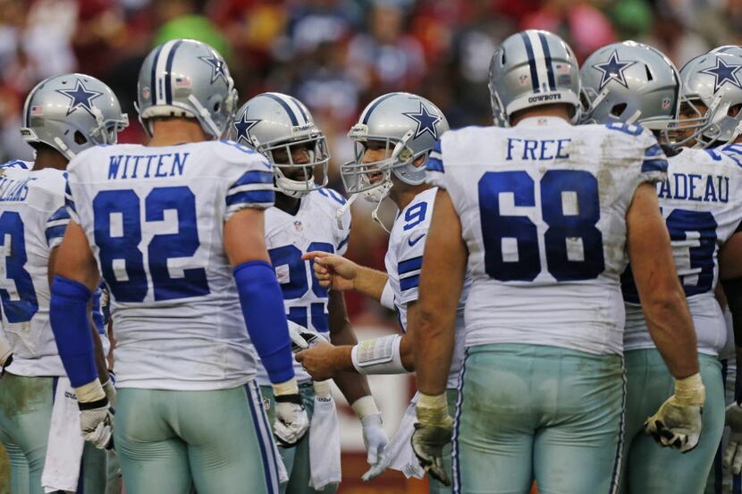 Dallas Cowboys quarterback Tony Romo (9) directs the team as they started their game-winning...