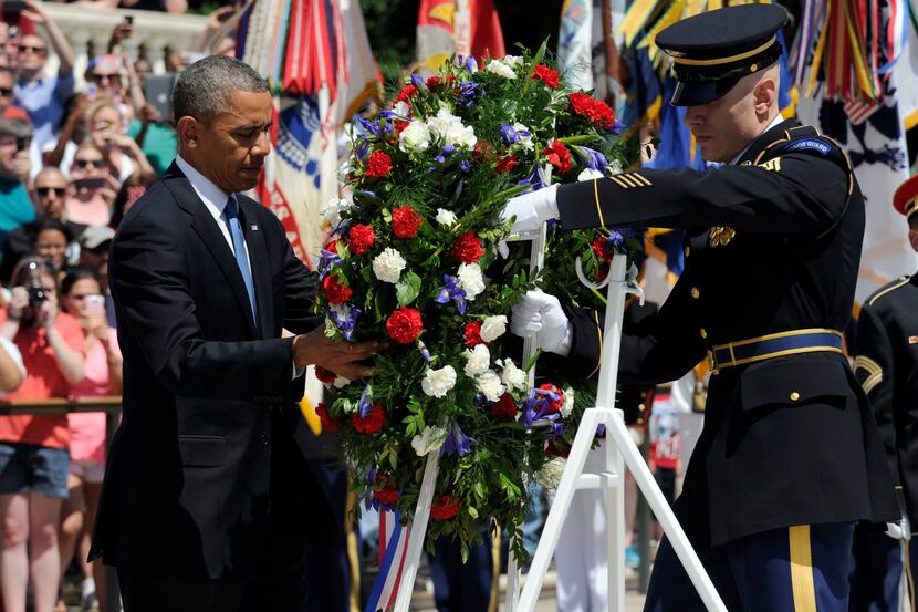 President Barack Obama lays a wreath at the Tomb of the Unknowns at Arlington National...