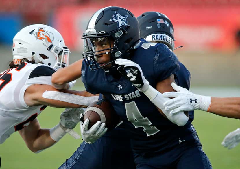 Lone Star High School  wide receiver Jaylon Braxton (4) looks for room to run after the...