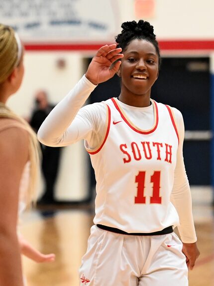 South Grand Prairie’s Jahcelyn Hartfield (11) and Kendall McGruder celebrate their 61-45 of...