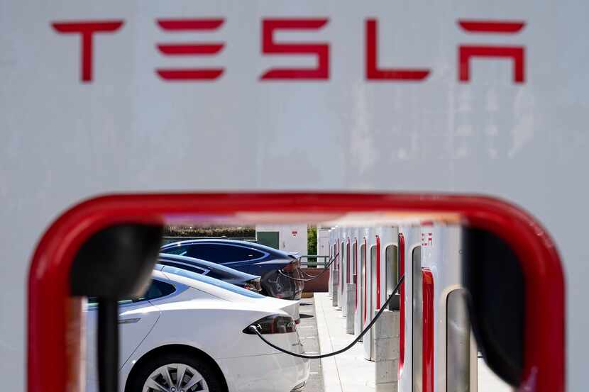 Tesla vehicles charge at a station in Emeryville, Calif., on Aug. 10, 2022. Writers Brett...