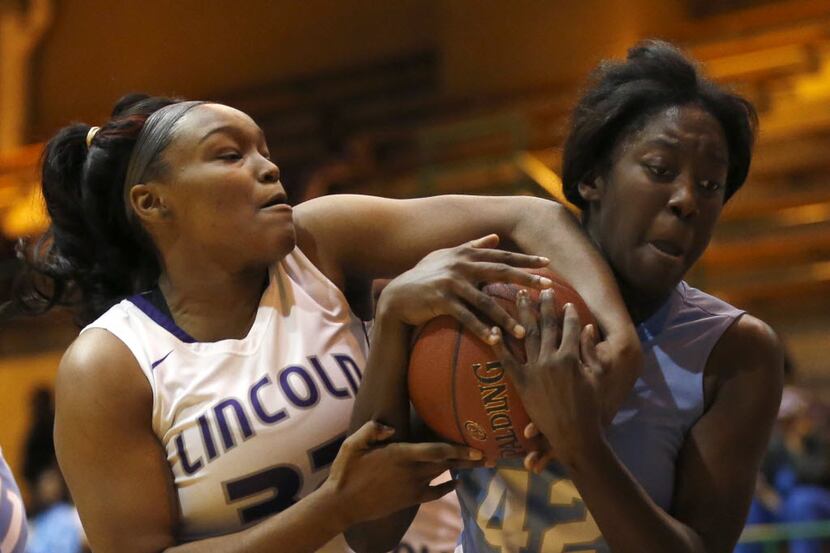 Lincoln Lady Tigers post Jalah Walton (32) and Roosevelt Lady Mustangs post Desirae Devine...