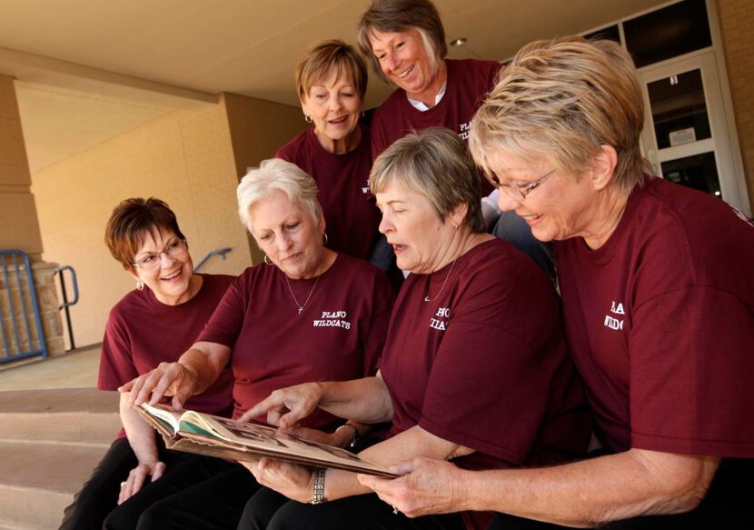 
Members of the Plano High School class of 1965 look through a yearbook. The class is...