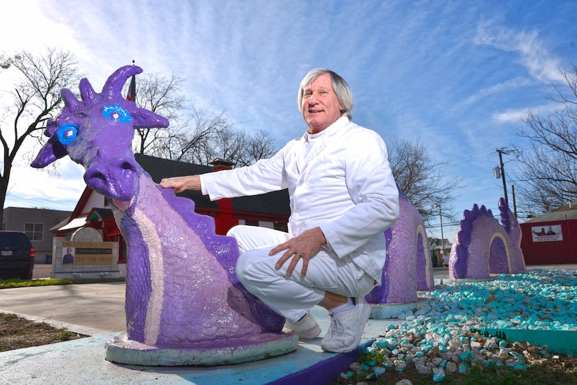 Dr. Steven Tutt and his dragons outside of his office at Cedar Springs Chiropractic in...