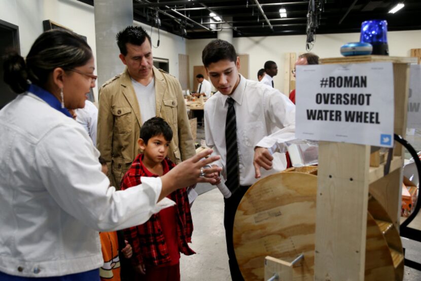 Student Junior Lopez, a 10th-grader in the school's engineering program, talks with the...