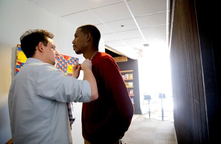 Young Guru (right) waits while Casey Gilblom, junior producer at The Marketing Arm, places a...