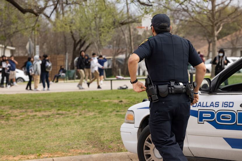 DISD police Officer Uzziel Avila headed toward a group of students “slap boxing” one another...