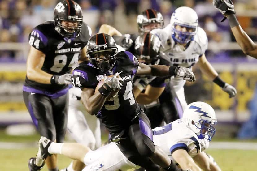 TCU tailback Ed Wesley (34) looks for room against the Air Force defense during a college...