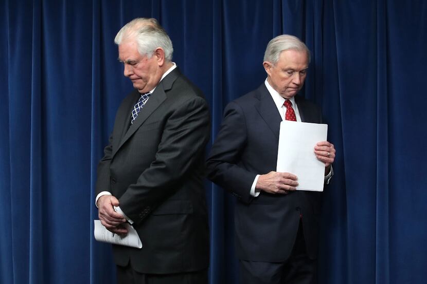 Secretary of State Rex Tillerson, left, and Attorney General Jeff Sessions take part in a...