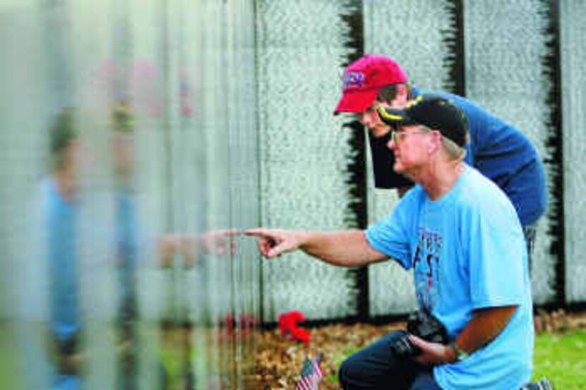  Larry Maddux pointed out the name of a high school friend, James R. Teffs, to grandson Alex...