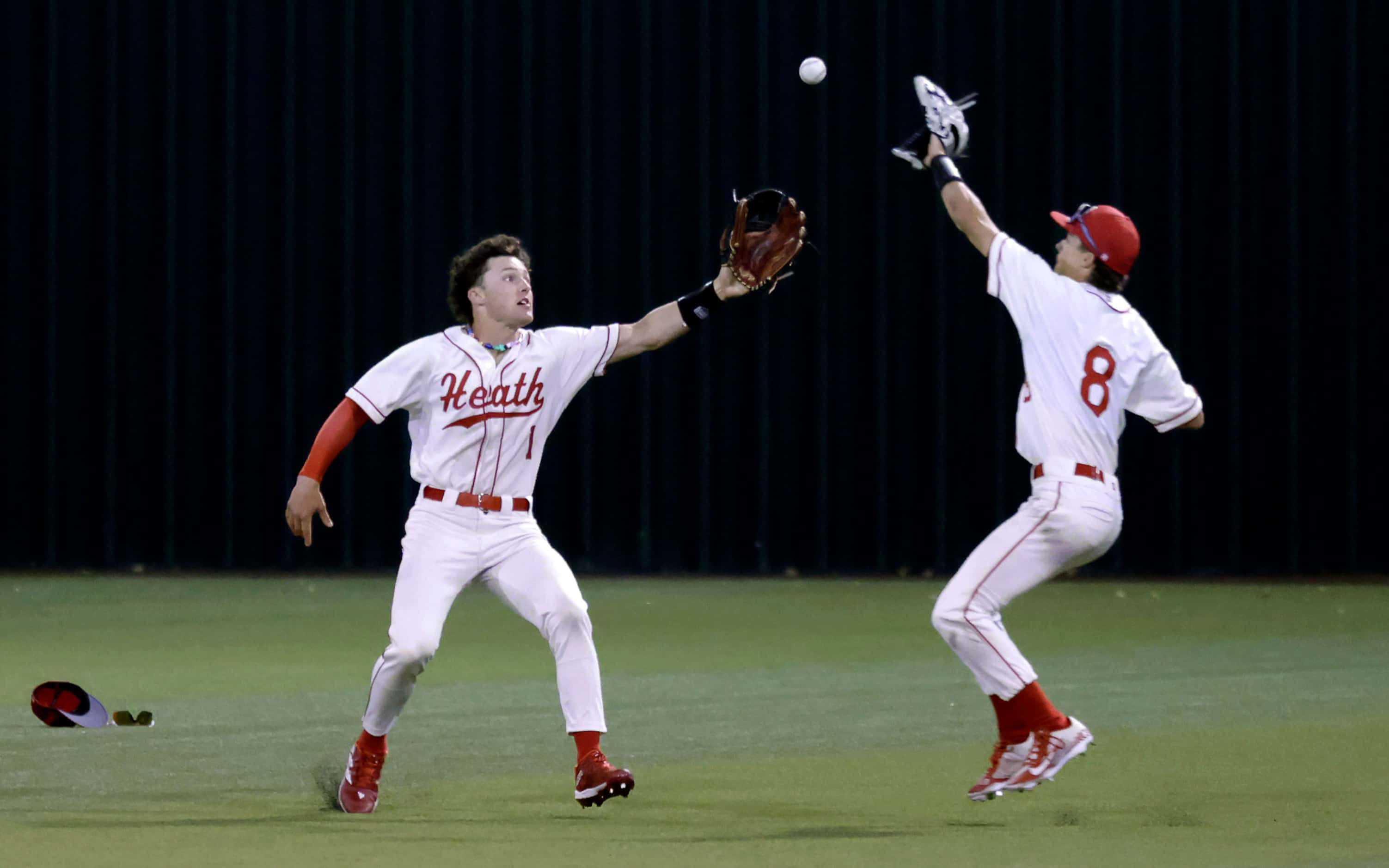 Rockwall-Heath High (1) and (8) field a ball on the hop from Celina High batter Major...