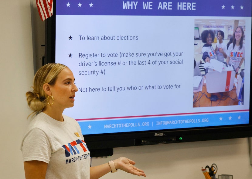 Hannah Kessler, a volunteer of voter registration group March to the Polls,  talks to...