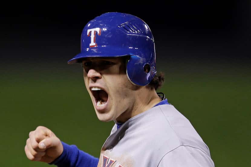 Texas Rangers' Ian Kinsler reacts after teammate Elvis Andrus reached second base during the...