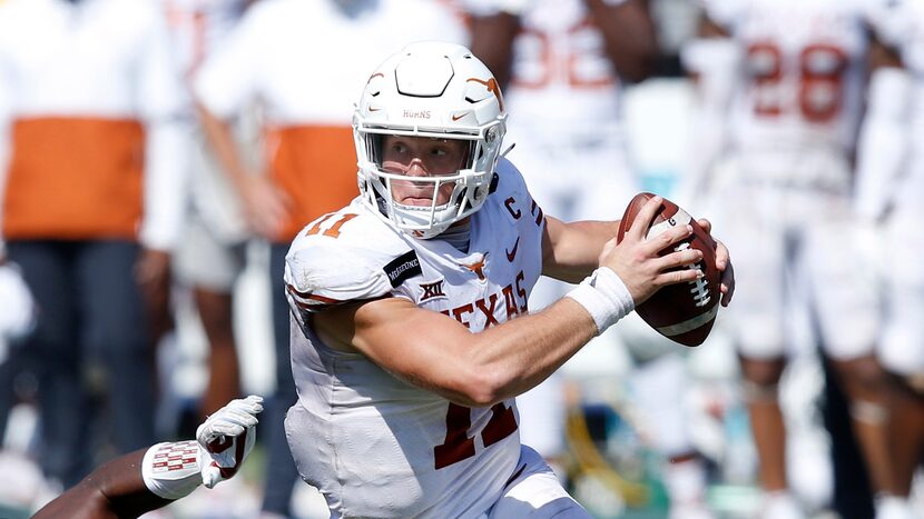 Texas Longhorns quarterback Sam Ehlinger (11) spins away from Oklahoma Sooners defensive...