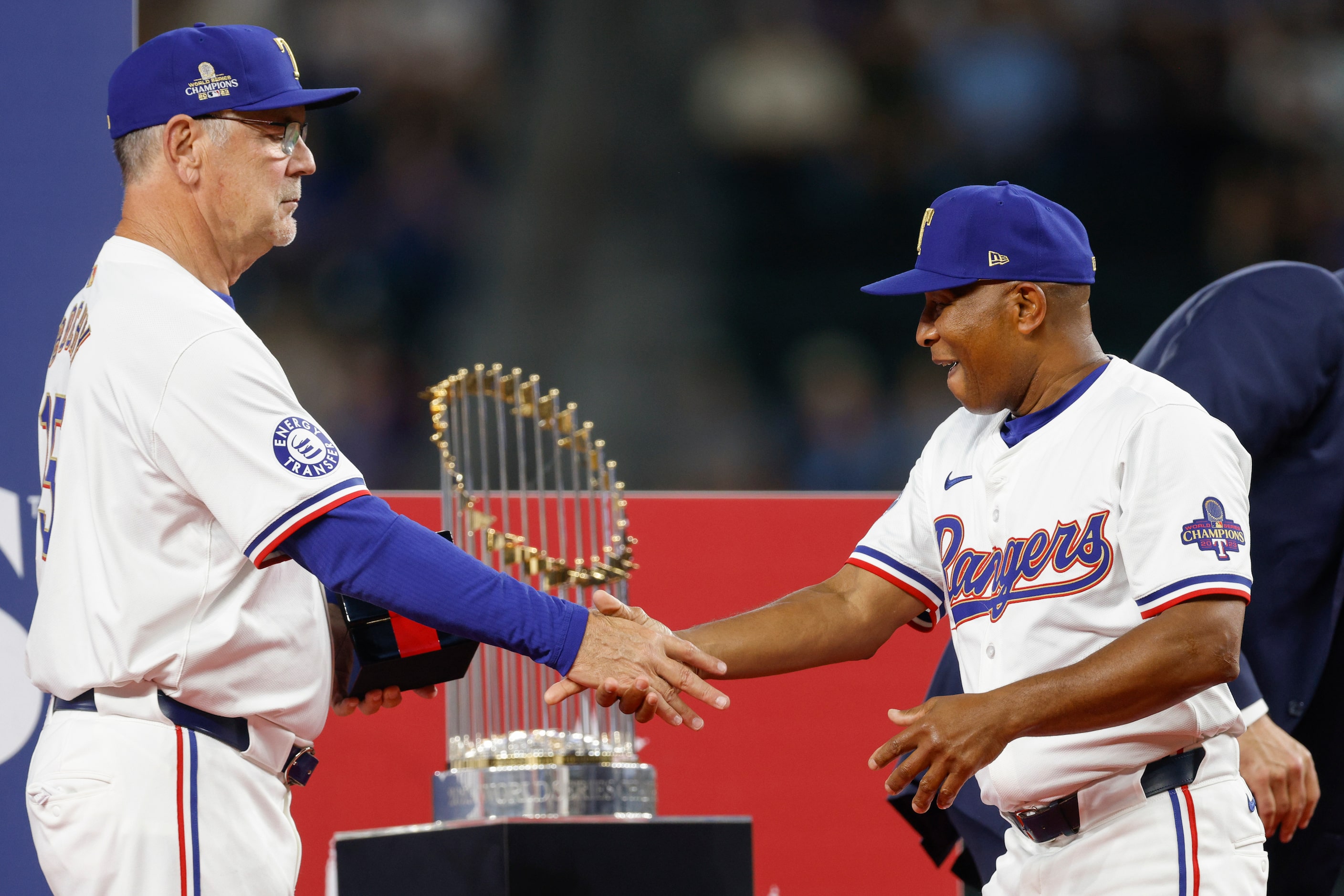 Texas Rangers manager Bruce Bochy shakes hands with third base coach Tony Beasley as he...