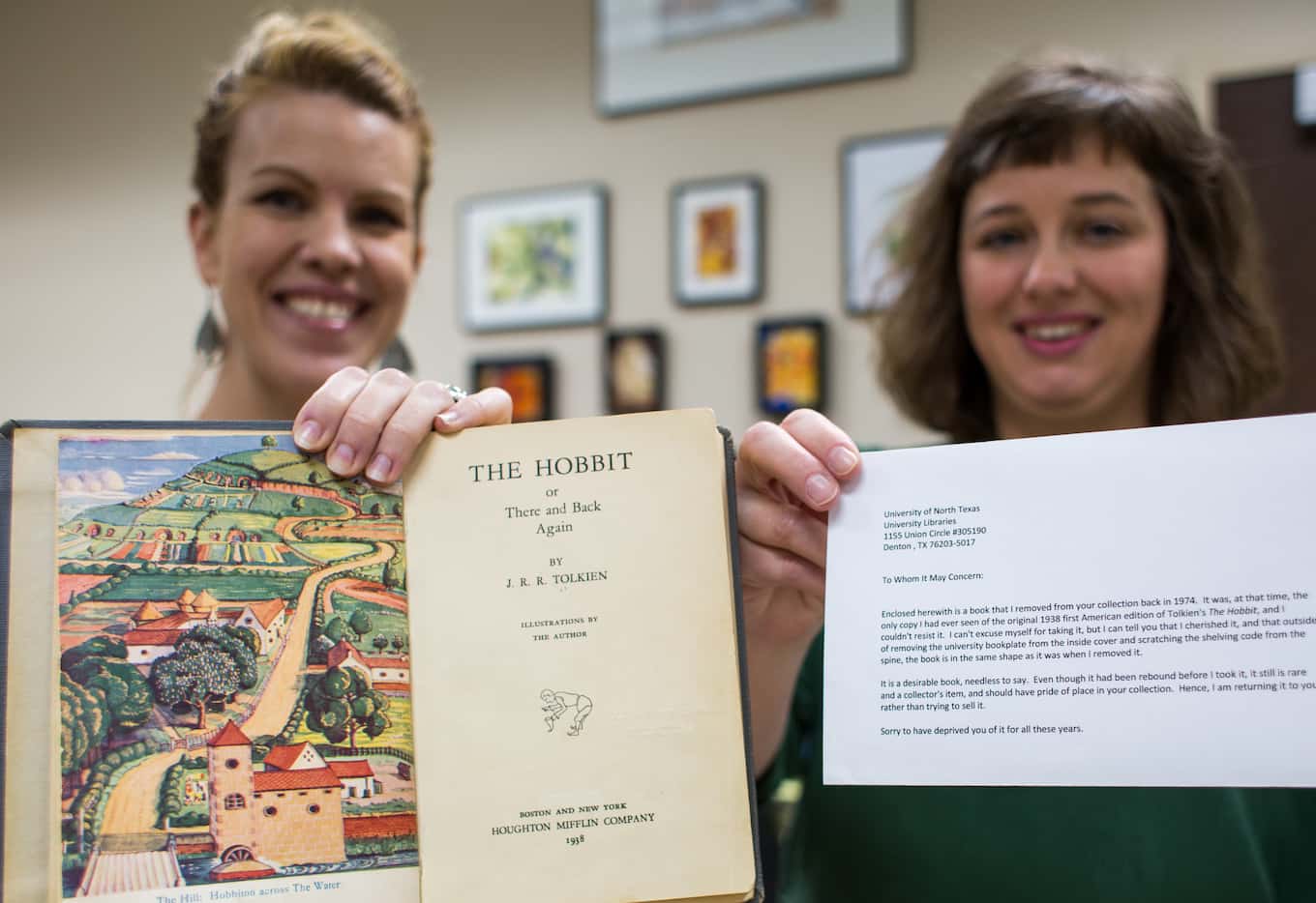 UNT librarians Laurel Crawford and Morgan Gieringer hold the first edition 1938 copy of "The...