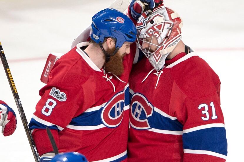 Montreal Canadiens goalie Carey Price (31) is congratulated by defenseman Jordie Benn (8)...
