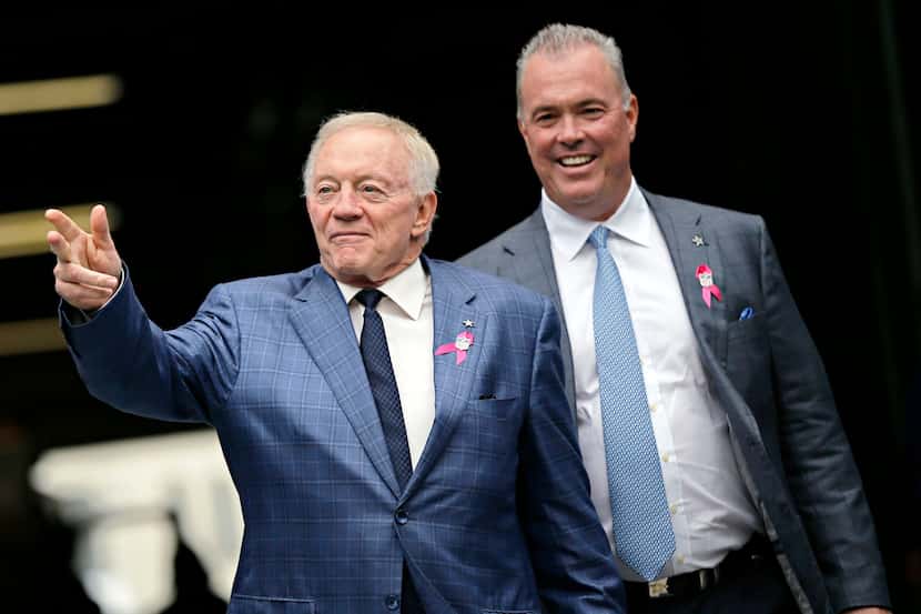Dallas Cowboys owner Jerry Jones (left) and his son, Stephen Jones, walk on the field before...