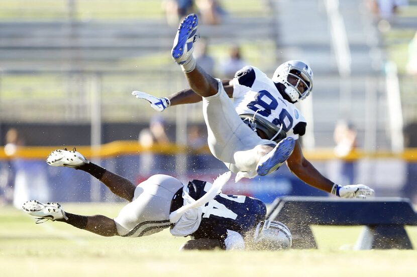 Dallas Cowboys cornerback Morris Claiborne (24) cuts the legs out from underneath wide...