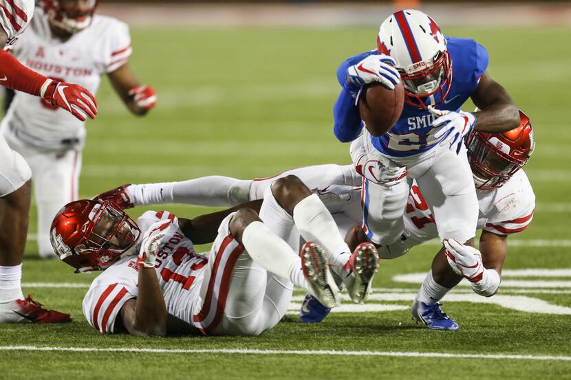 Southern Methodist Mustangs wide receiver Myron Gailliard (22) is brought down by Houston...