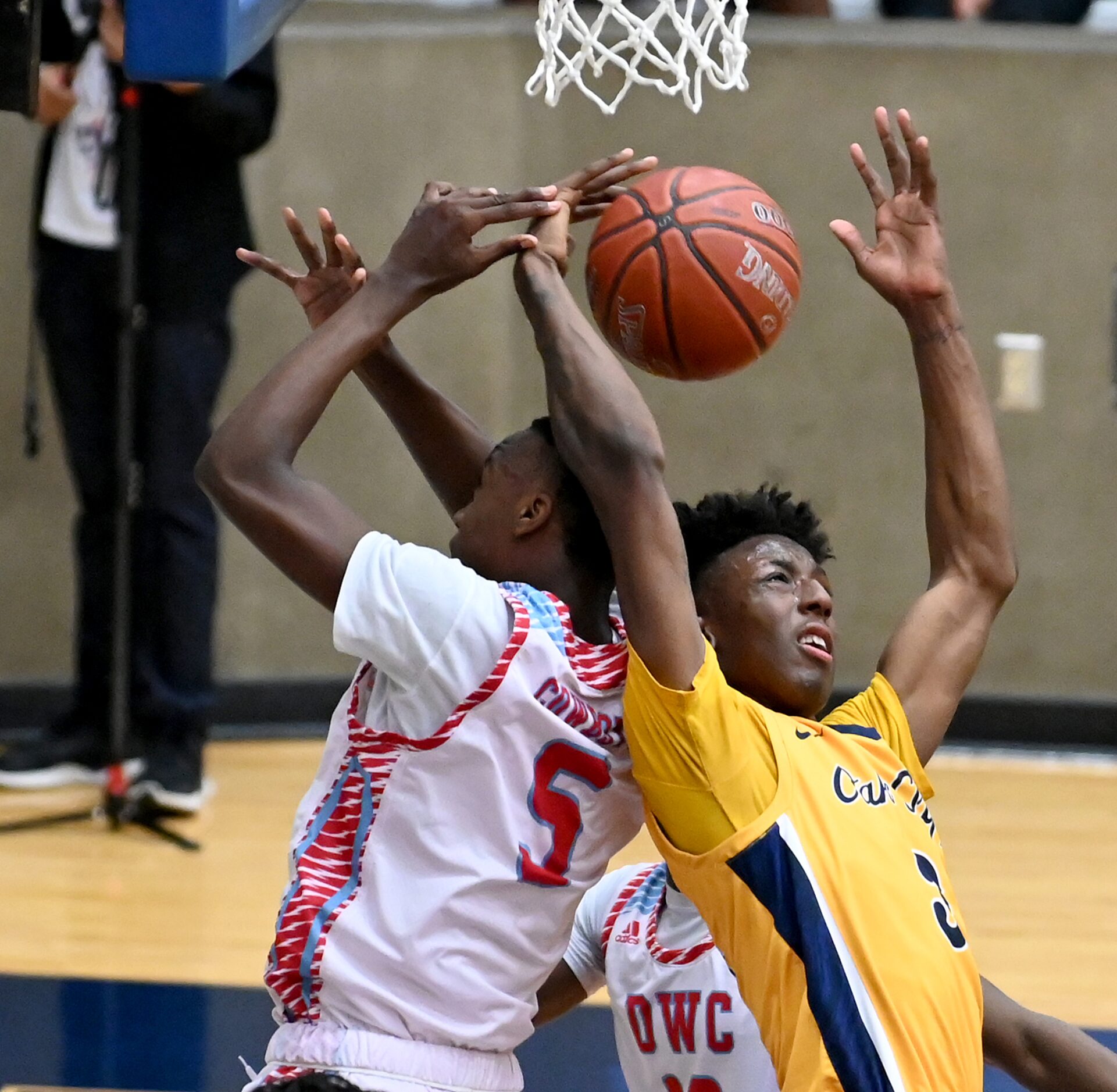 Faith Family’s Robert Haynes (3) goes after a rebound with Carter’s Chance Puryear in the...