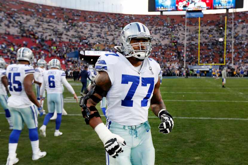 Dallas Cowboys offensive tackle Tyron Smith (77) jogs out for warmups before their NFC...