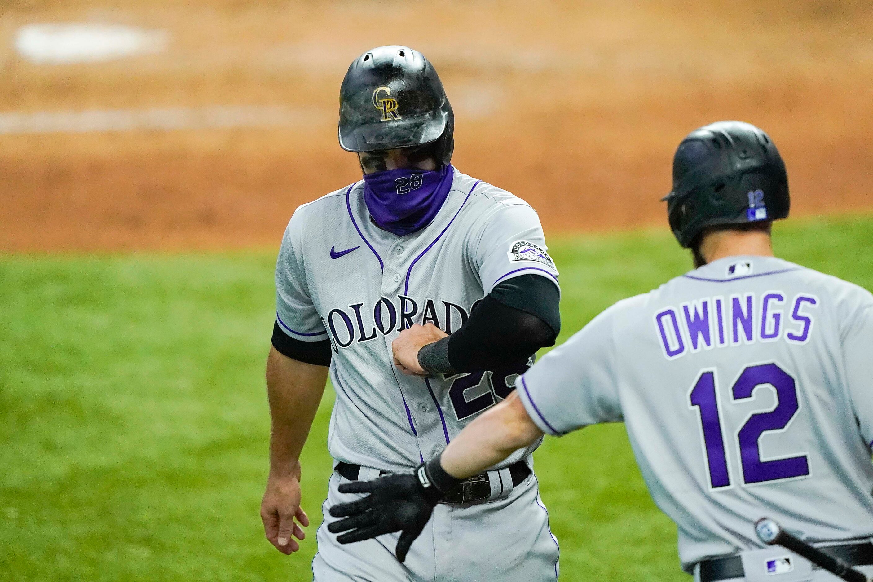 Colorado Rockies third baseman Nolan Arenado celebrates with second baseman Chris Owings...