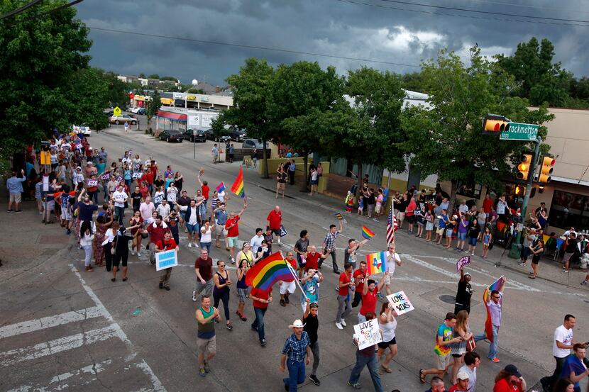 Gay couples and their families and friends marched down Cedar Springs Road after a rally at...