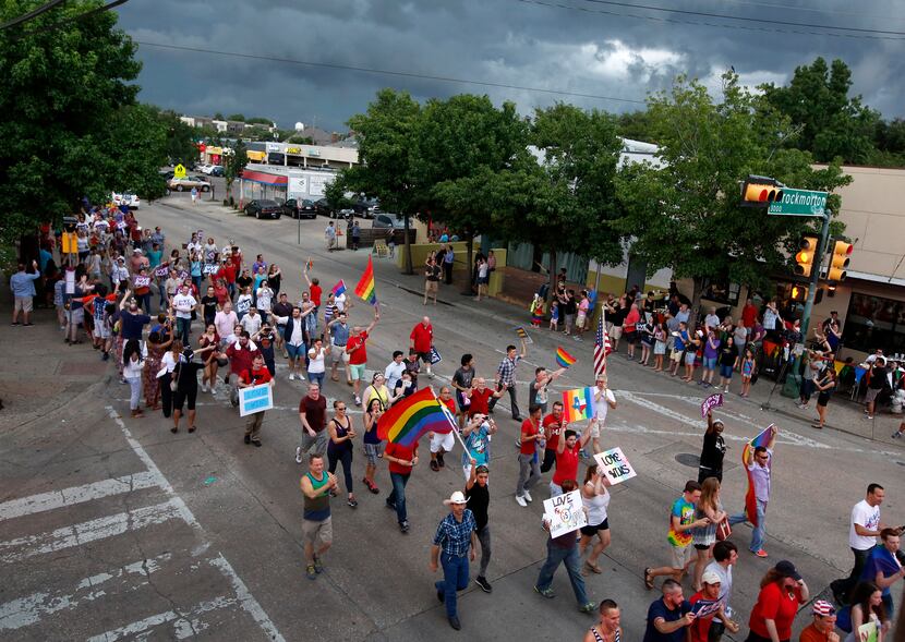Gay couples and their families and friends marched down Cedar Springs Road after a rally at...