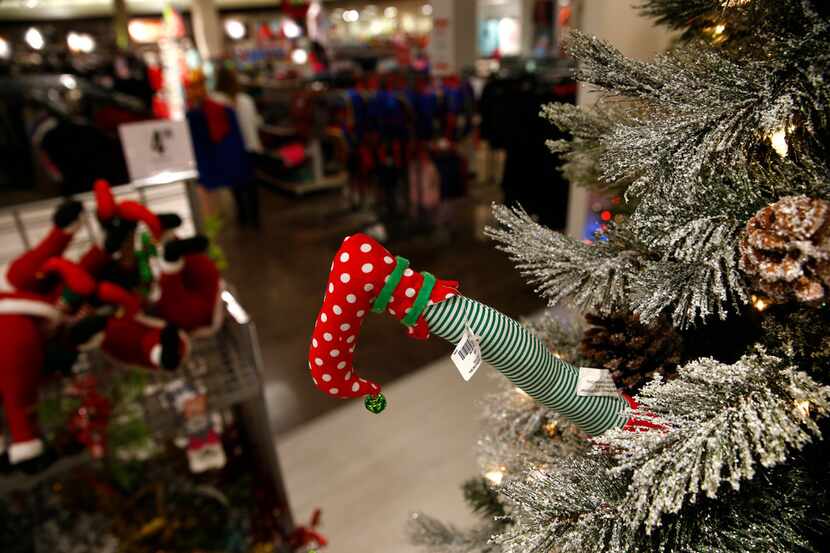 An Elf's foot sticks out of a Crhistmas tree in the Holiday section of J. C. Penney at...