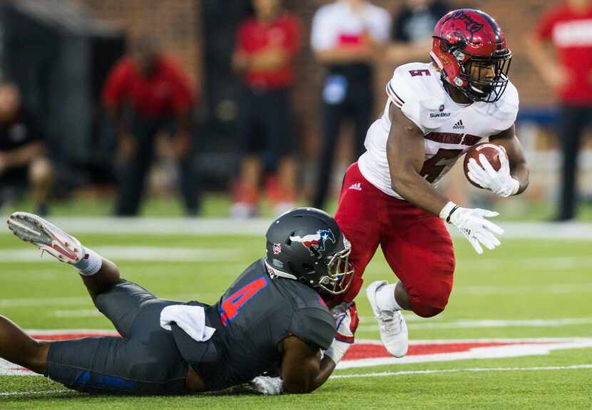 Southern Methodist Mustangs safety Mikial Onu (4) tackles Arkansas State Red Wolves running...