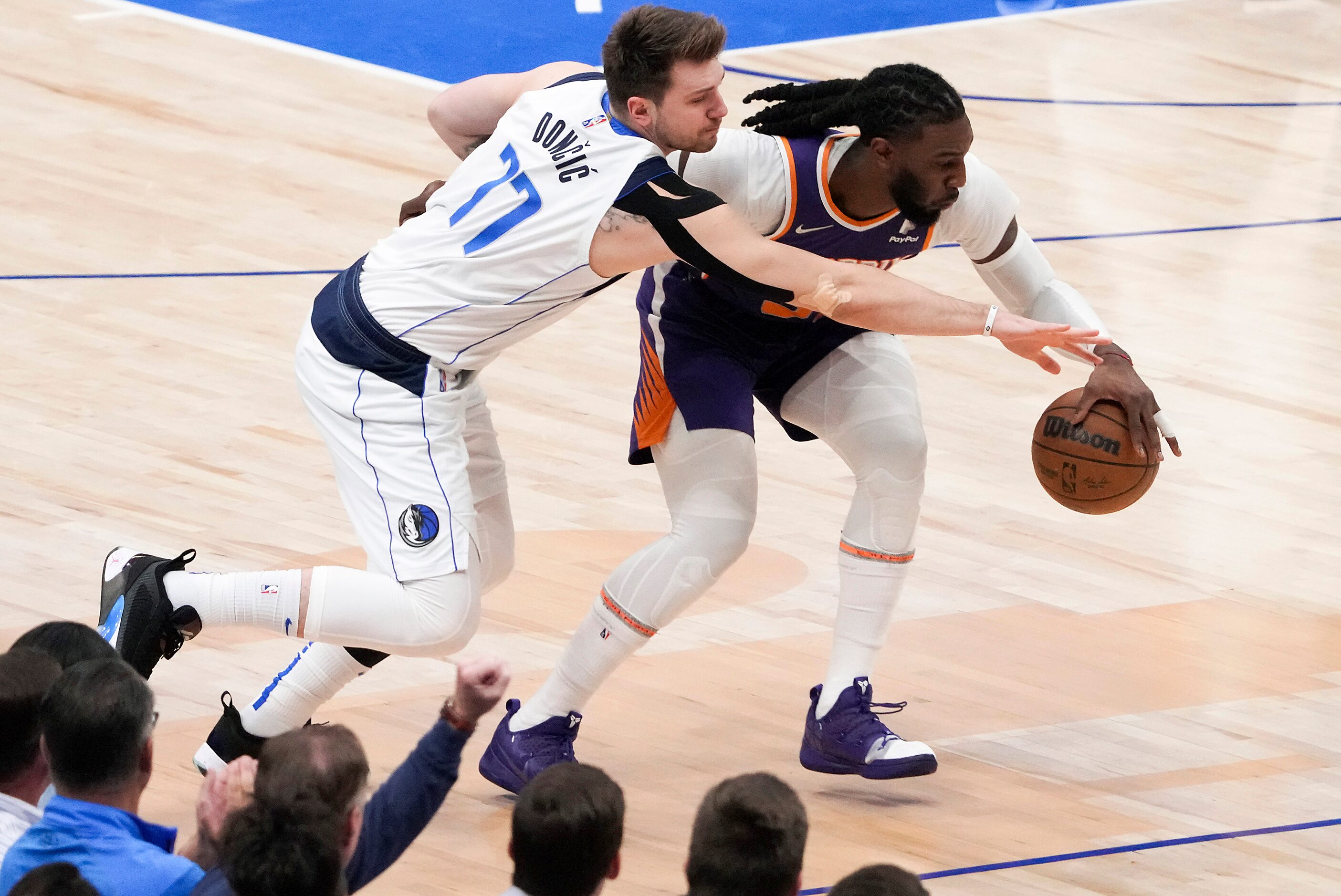 Dallas Mavericks guard Luka Doncic (77) tries to steal the ball from Phoenix Suns forward...