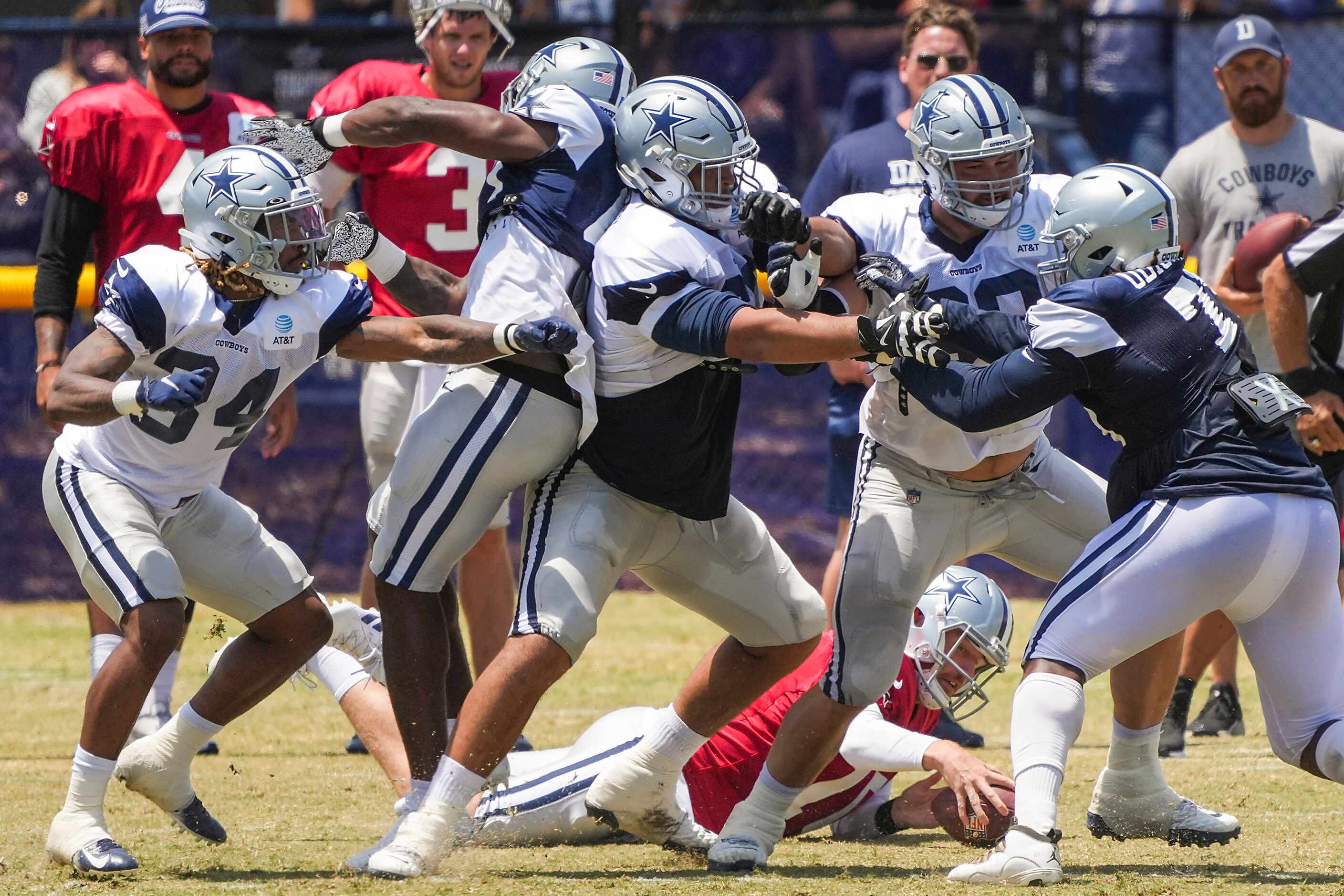 Dallas Cowboys quarterback Cooper Rush (10) recovers a fumbled snap during a practice at...