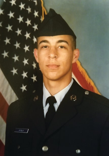 A photo of young Angel Ayala wearing his Air Force uniform with the American flag in the...