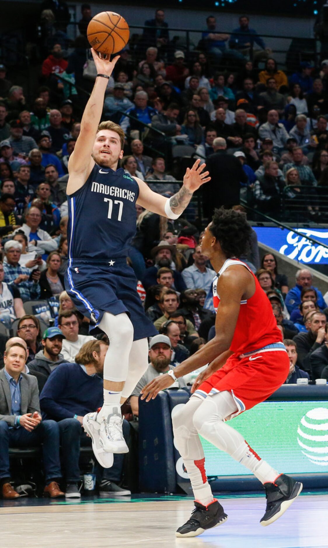 Dallas Mavericks guard Luka Doncic (77) goes up for a shot over Sacramento Kings guard...