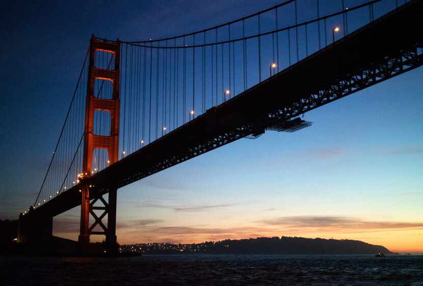 The sun sets behind the Golden Gate Bridge on the expedition's return trip into San...