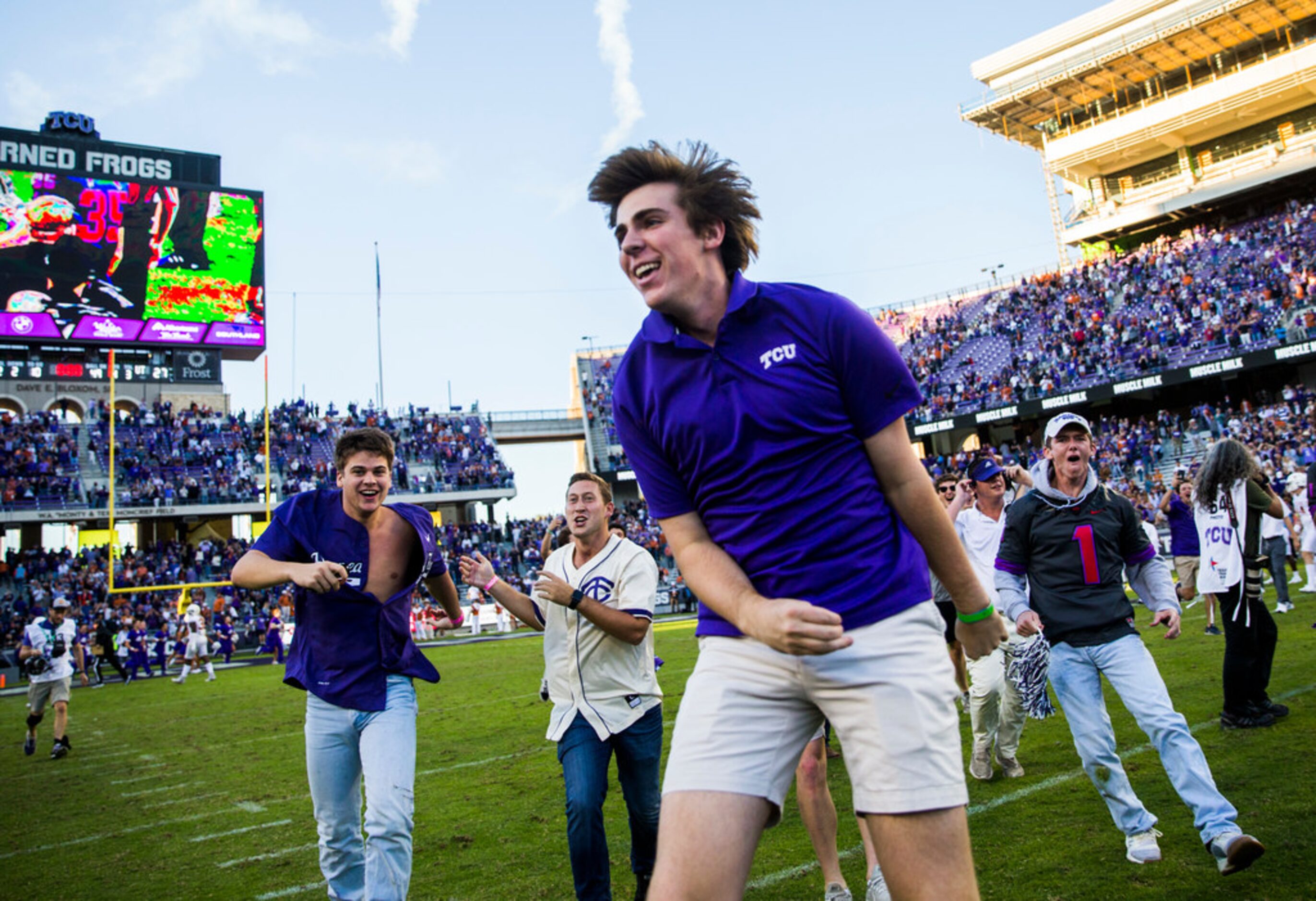 TCU Horned Frogs students and fans rush the field after a 37-27 TCU win over Texas on...