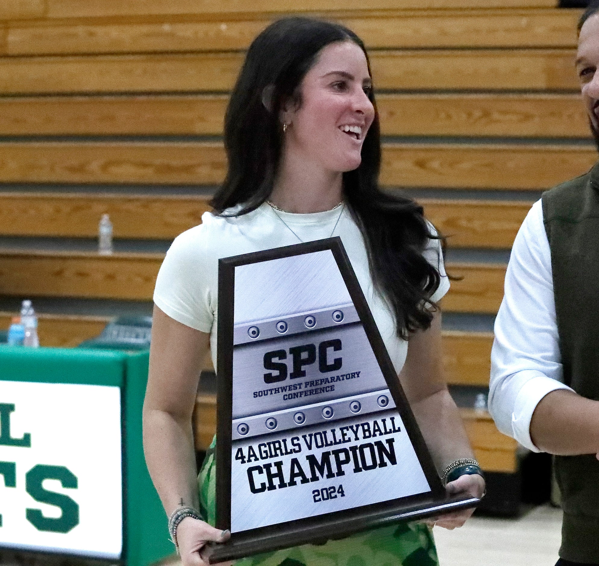 Hockaday head coach Allison Camp is awarded the state championship trophy after Hockaday...