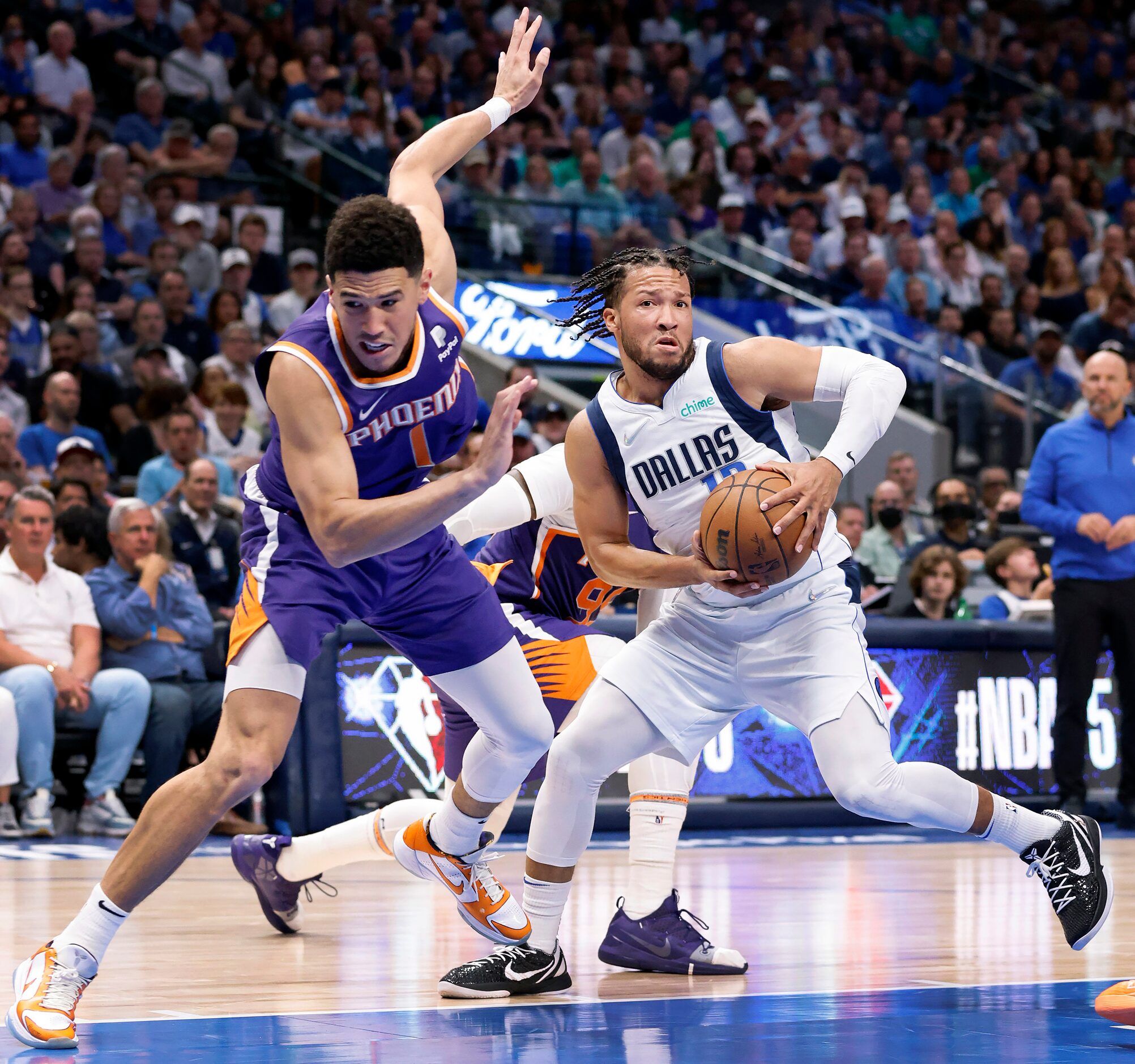 Dallas Mavericks guard Jalen Brunson (13) makes a move on Phoenix Suns guard Devin Booker...