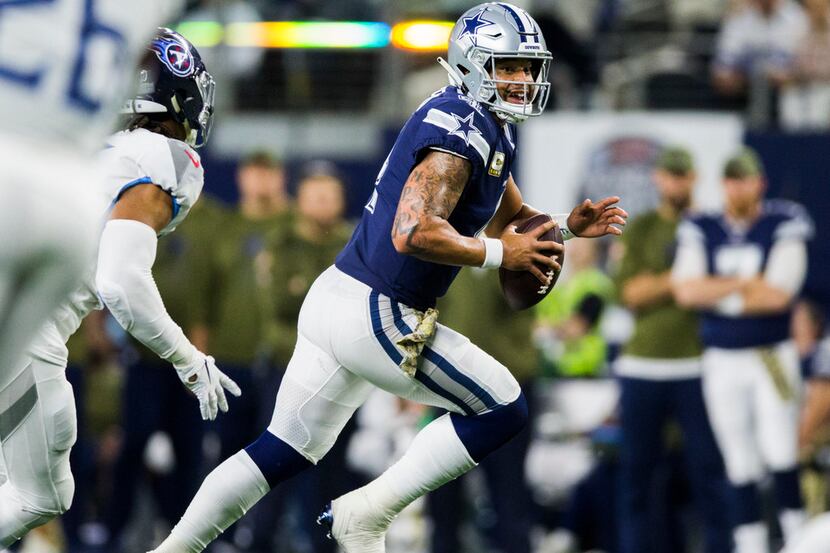 Dallas Cowboys quarterback Dak Prescott (4) runs the ball during the fourth quarter of an...