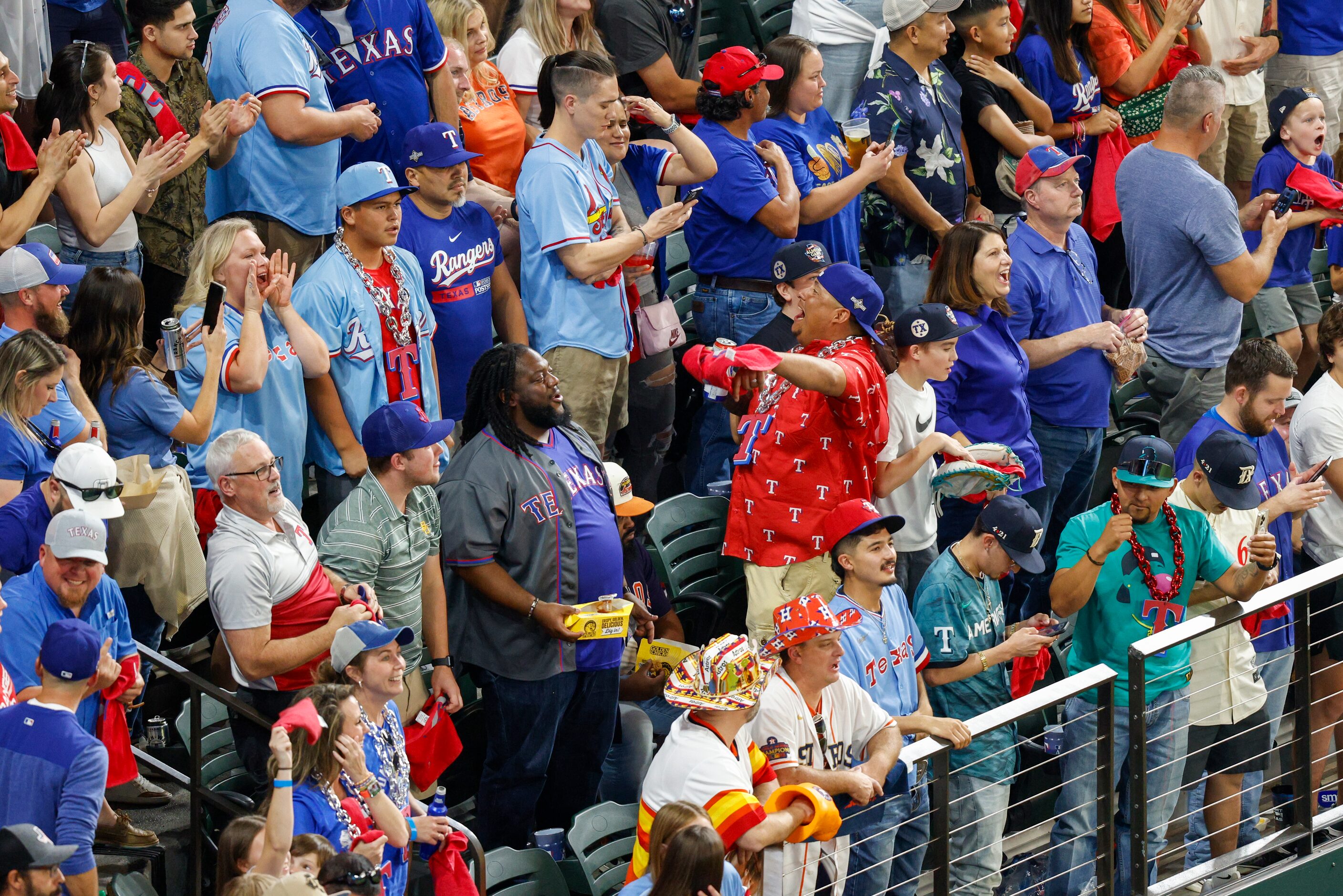 Texas Rangers fans celebrate home run by Texas Rangers right fielder Adolis Garcia during...