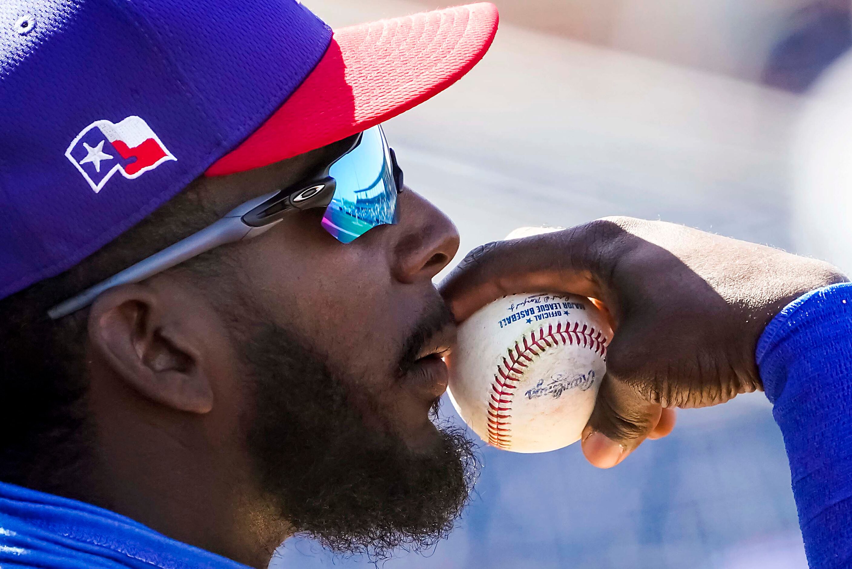 Texas Rangers infielder Sherten Apostel watches from the dugout during the second inning of...