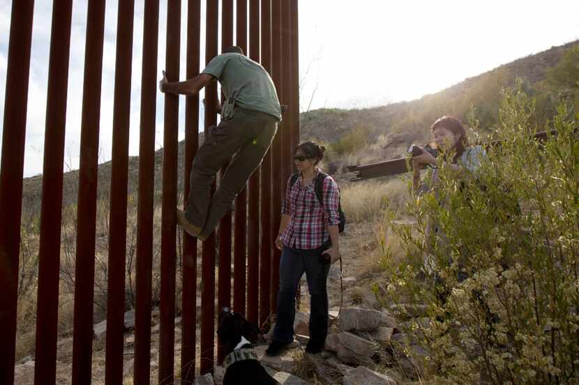 In this May 11, 2016, file photo, Tim Foley shows how to climb a section of the border wall...