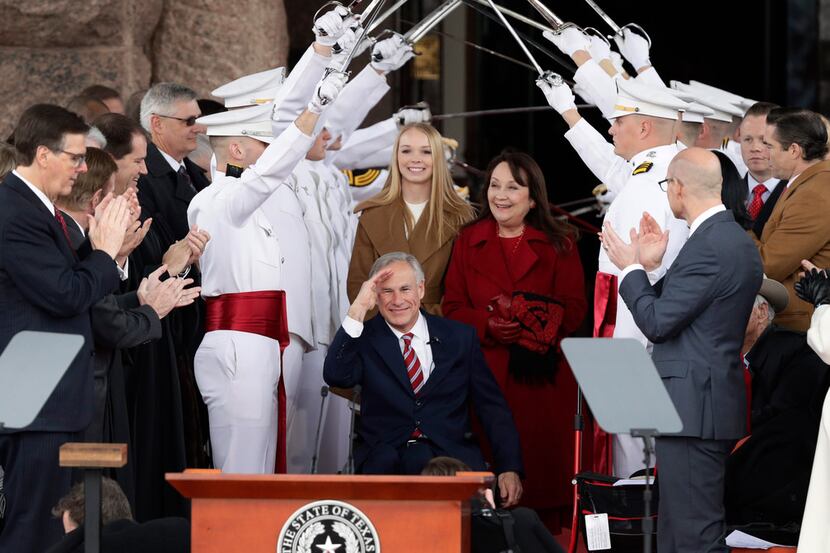 Texas Gov. Greg Abbott (front center) was sworn in last month as his wife, Cecilia, and...