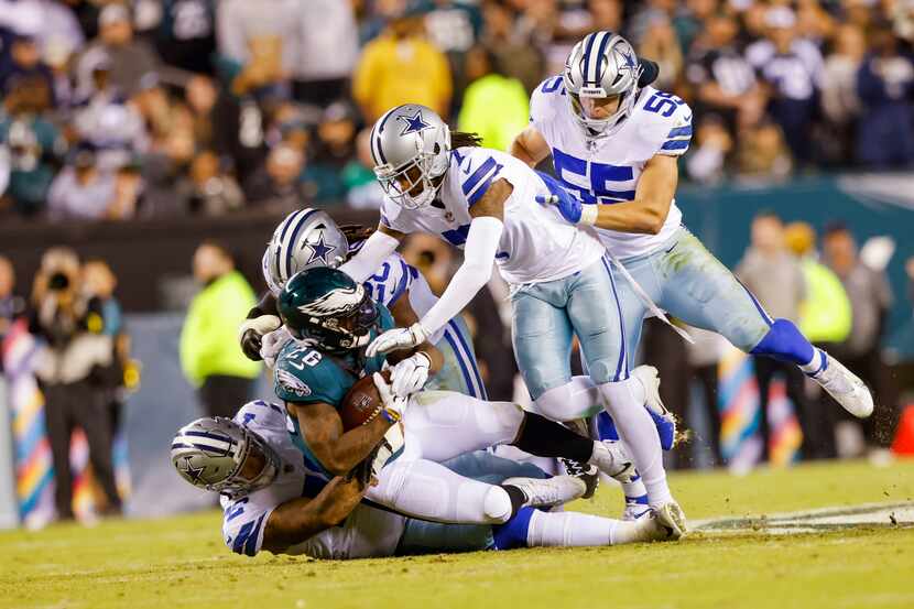 Philadelphia Eagles running back Miles Sanders (26) is tackled by the Dallas Cowboys defense...