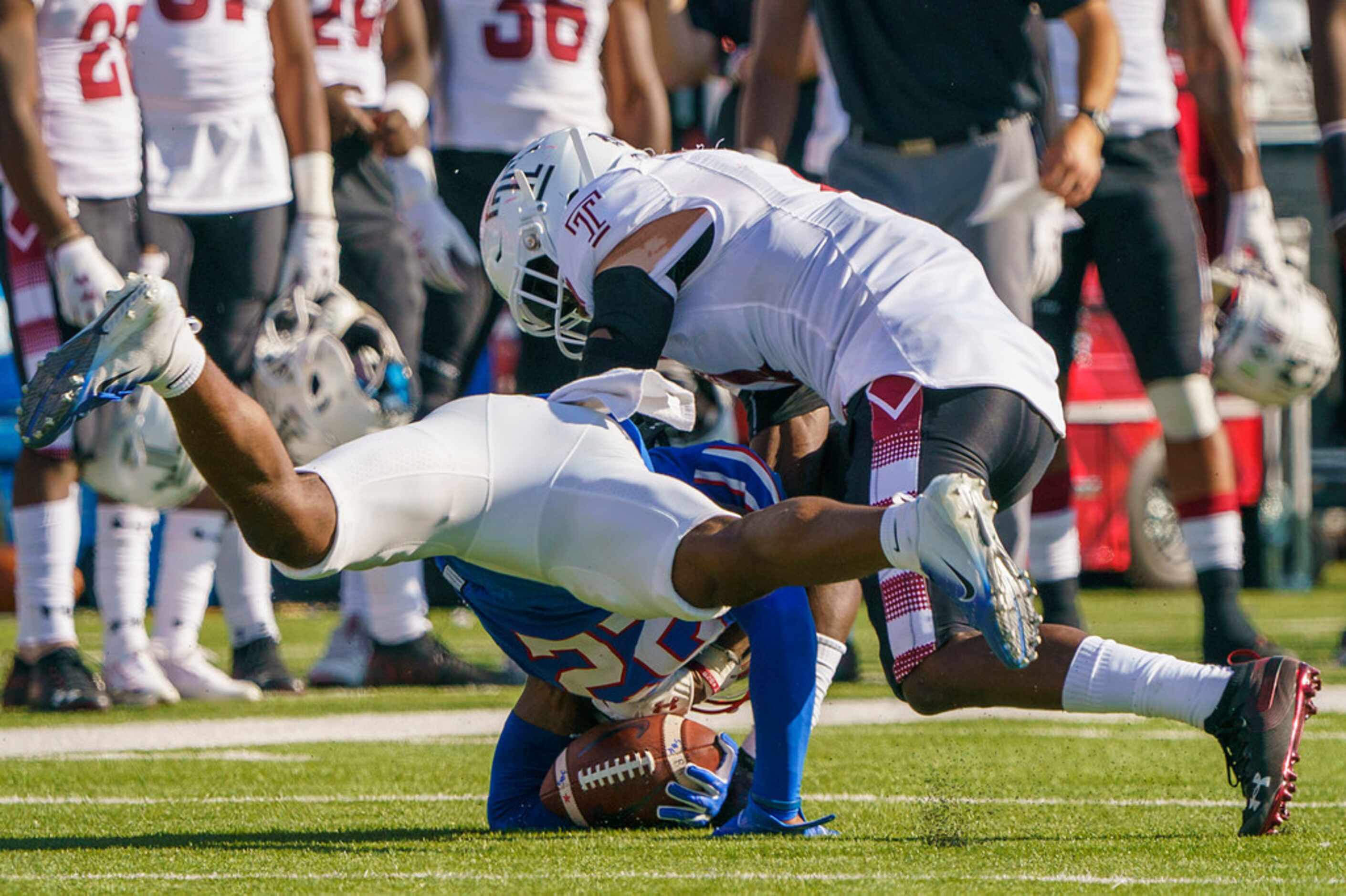 SMU wide receiver Myron Gailliard (22) hits the ground, causing a fumble that was initially...