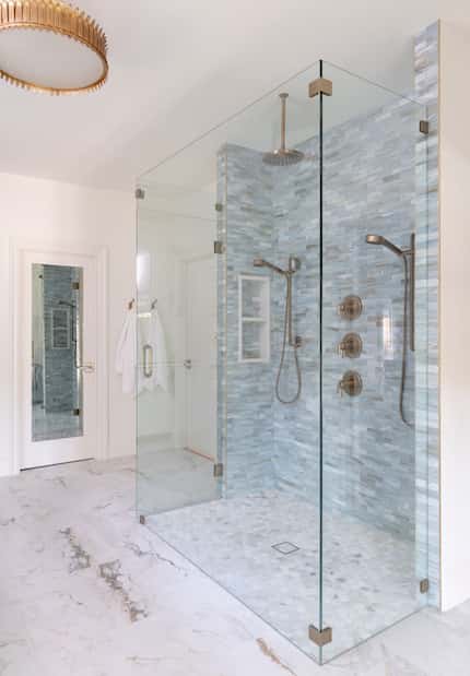 Studio Steidley designed this coastal-inspired shower and primary bathroom as an homage to...