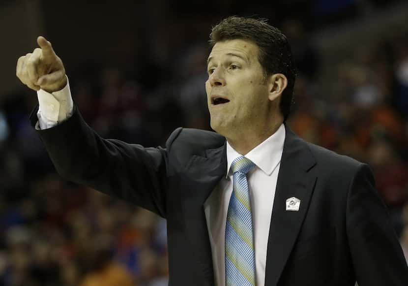 UCLA head coach Steve Alford speaks to players during the first half in a regional semifinal...