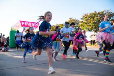 Girls raced ahead at the start of the Girls on the Run DFW Metroplex 5K at Lone Star Park in...